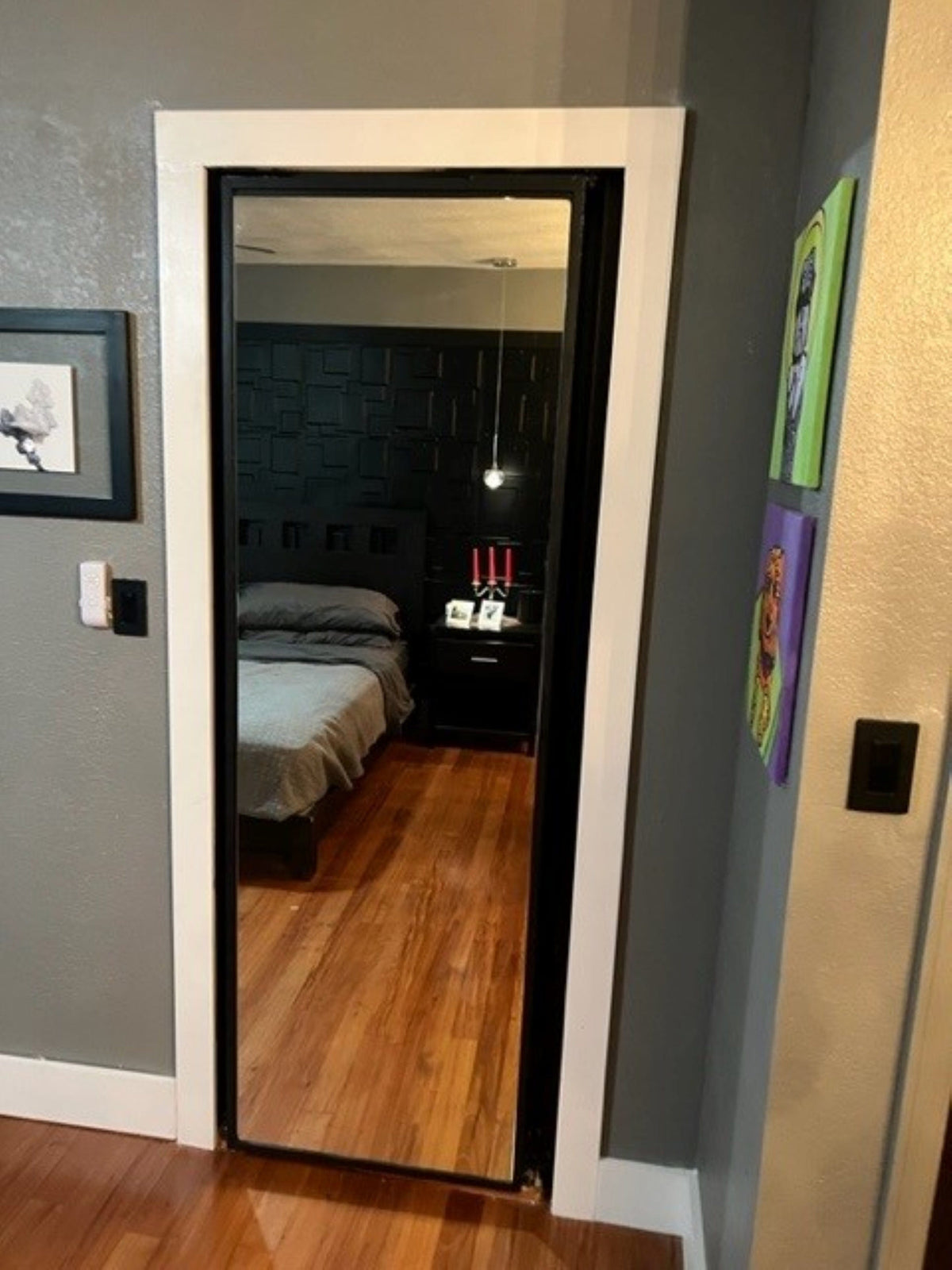Rear-facing mirror installed on back of hidden bookcase door