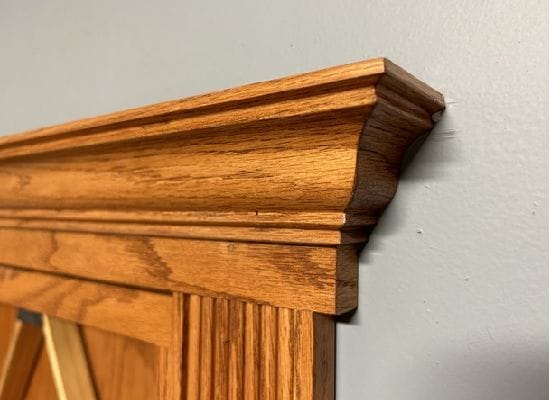 Basic crown molding installed above a hidden bookcase door