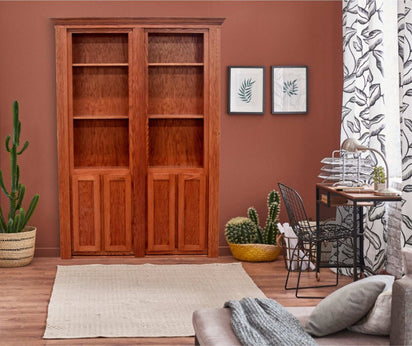 Double hidden bookcase door made of wood installed in living room with plants and desk