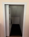 White hidden attic doors by Hide-A-Way-Doors opening to reveal storage space under stairs