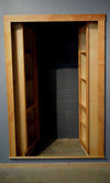 Hidden bookcase double door by Hide-A-Way Doors with natural wood frame and shelving inside