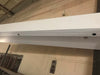 White hidden door top seal for out-swing doors by Hide-A-Way-Doors installed on a wall
