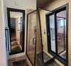 Hide-A-Way Doors hidden mirror door with black frame installed in bathroom beside glass shower