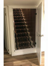 White hidden mirror door by Hide-A-Way Doors concealing staircase with carpet runner