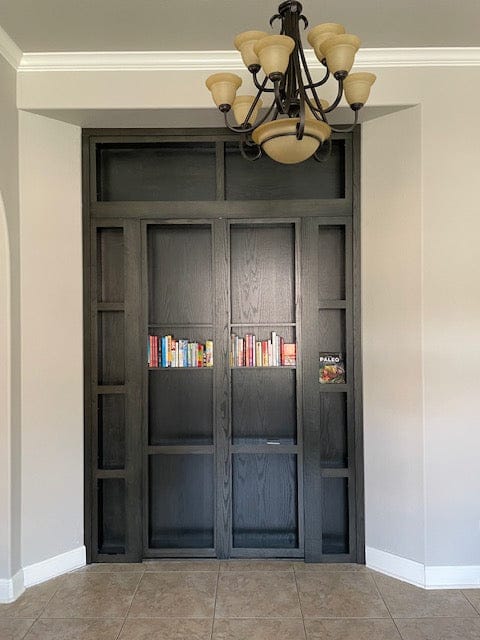 Finished custom hidden door wall unit shown closed