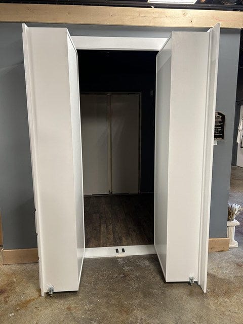 Double out-swing hidden bookcase doors showing reduced pass-through