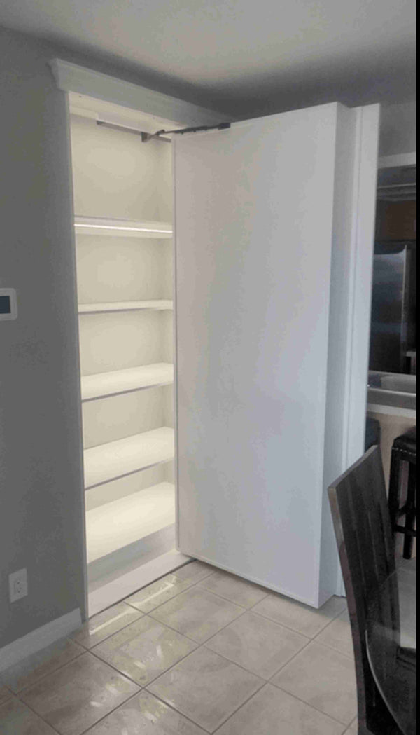 White bookcase hidden door in a room with tiled floor and gray walls.