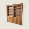 Hide-A-Way-Doors wooden hidden bookcase door with shelves and cabinet panels in natural finish