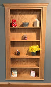 Hide-A-Way-Doors wooden hidden bookshelf door with shelves displaying decorative items and flowers