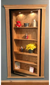 Hide-A-Way-Doors wooden hidden bookshelf door with shelves displaying decor and built-in lighting