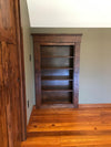 Hide-A-Way-Doors wooden hidden attic doors with built-in shelves in a polished wood finish