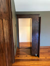 Hide-A-Way-Doors hidden attic doors with dark wood finish open in a room with wooden floor