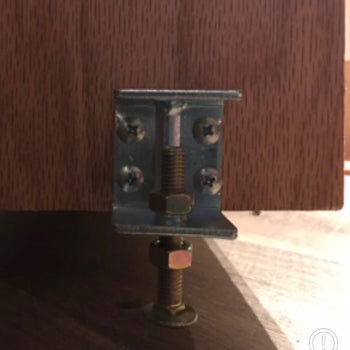 Close-up of a hidden bookcase door latch metal mechanism on a wooden hidden door by Hide-A-Way-Doors