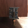 Close-up of a hidden bookcase door latch metal mechanism on a wooden hidden door by Hide-A-Way-Doors