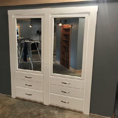 White hidden closet organizer door by Hide-A-Way-Doors with mirror panels and drawer handles