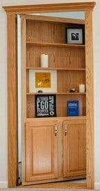 Hide-A-Way-Doors hidden bookcase door with wooden shelves and storage cabinets in oak finish